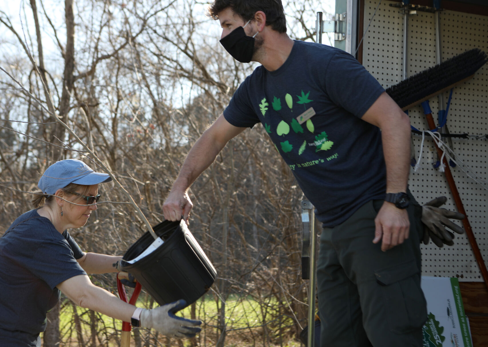 Terri Sallee takes a tree from Mark Halpin